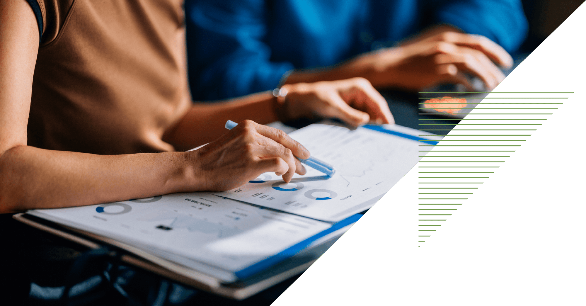 hands of two coworkers review paperwork with charts and graphs hands of two coworkers review paperwork with charts and graphs